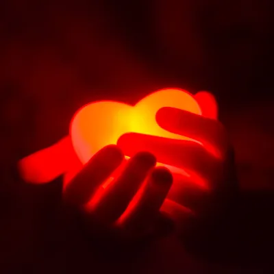 Glowing heart held in two hands.